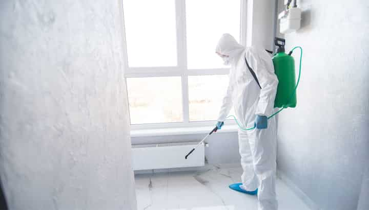 A certified mold inspector using specialized equipment to identify and locate mold growth in a residential property in Topsham